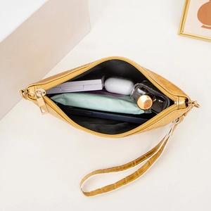 Golden stone textured crossbody bag with zip closure showing spacious internal storage