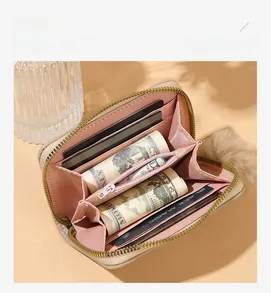 Detail of multi-slot card holder and pink zipper coin pocket in a faux leather wallet