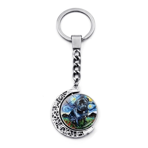Close-up of rotatable silver keychain featuring Van Gogh style Pug art in moon frame