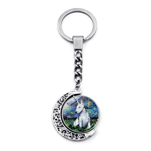 Rotating keychain featuring a Bull Terrier portrait in a starry night crescent moon frame