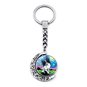 Detailed view of silver moon pendant with Van Gogh style Papillon dog oil painting