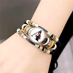 Layered leather bracelet with vintage beads and glass flower pendant featuring letter A