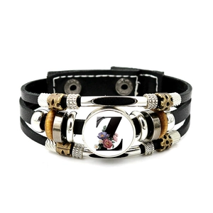 Detail of multi-layer black leather bracelet featuring letter Z and wooden beads