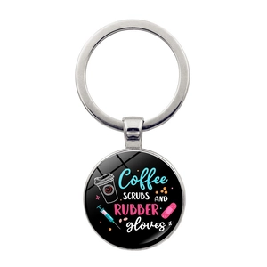 Close-up of nurse keychain with coffee scrubs and rubber gloves text on glass dome