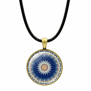Detail of vintage mandala glass pendant with bronze frame and black cord necklace