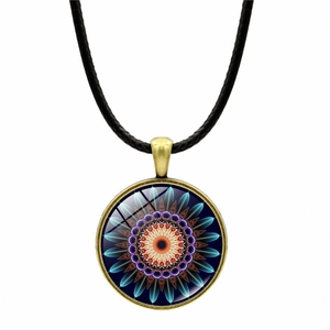 Macro shot of vintage mandala glass pendant with symmetrical blue-purple floral patterns