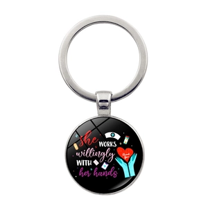 Macro detail of nurse keychain with medical heart and quote art on a round pendant
