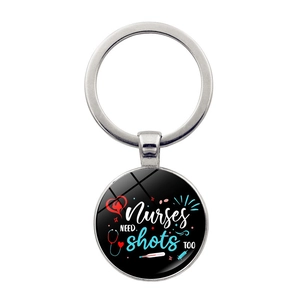 Macro detail of nurse gift keychain with medical heart and syringe graphic pendant
