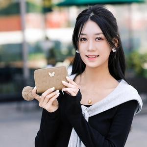 Khaki quilted PU leather short wallet featuring a silver butterfly buckle and fur pompom