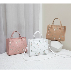 Detailed embroidery craft on floral square handbags in pink, white and tan leather