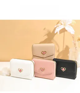 Selection of compact women's wallets in various colors featuring heart metal clasps