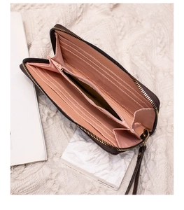 Detailed interior of long zipper wallet showing card slots and pink lining compartments