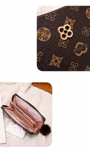 Detailed view of women's long wallet with brown pattern material and pink interior compartments