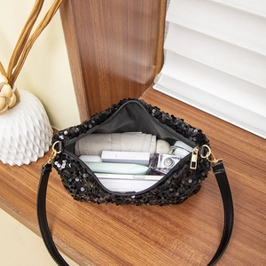 Fashionable black sequin shoulder bag showing spacious interior with daily essentials