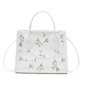 Chic white PU leather handbag with floral embroidery and adjustable strap in front view