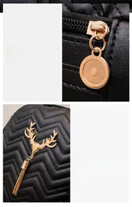 Detail of black quilted leather backpack with gold zipper and deer tassel charm
