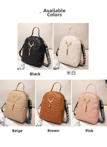 Detail of five colors of mini backpacks with V-quilting and deer head metal pendants