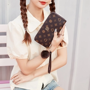 Women's vintage brown monogram long wallet with zipper and pompom charm detail
