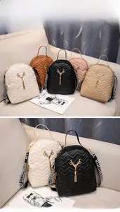 Detail showing various colors of quilted backpacks with deer head metal ornaments