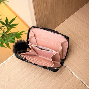 Black PU leather wallet with butterfly badge, pompom zipper, and pink interior compartments