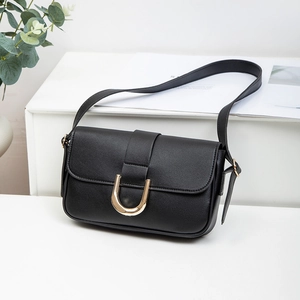 Vintage black crossbody bag with gold U-shaped buckle and textured leather finish