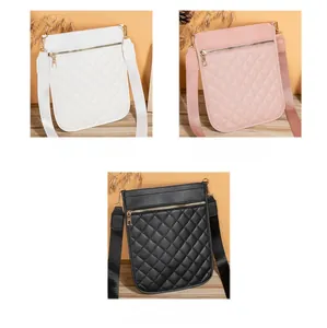 Detailed view of quilted crossbody bags in white, pink, and black with wide straps
