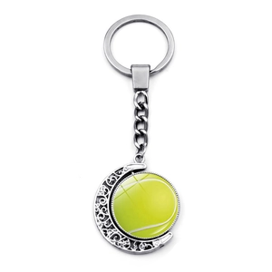 Double-sided spinning tennis ball keychain with moon-shaped hollow metal frame
