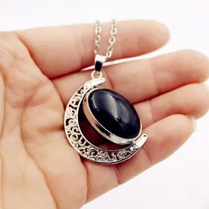 Custom silver crescent moon necklace with a rotatable black pendant tray for photos