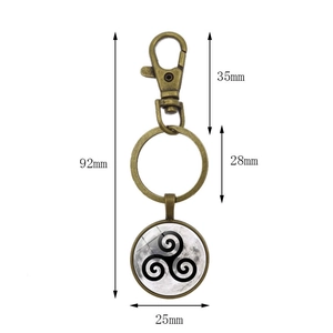 Detail of bronze lobster clasp keychain showing Celtic Triskelion moon glass pendant