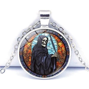 Macro view of gothic Grim Reaper pendant featuring a colorful stained glass window pattern