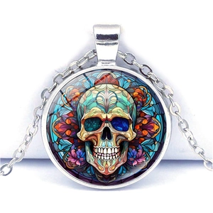 Macro shot of Halloween sugar skull glass pendant with silver alloy chain on white background