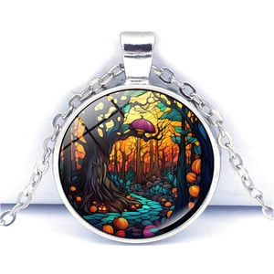 Close-up of Halloween ghost necklace pendant with black forest and pumpkin art
