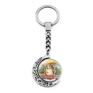 Rotating crescent moon keychain with cartoon hedgehog playing violin on silver metal frame