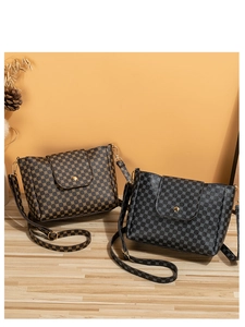 Detailed view of bucket bags with vintage floral print and gold metal buckles