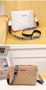 Detail of white and khaki quilted crossbody bags with letter print wide straps