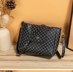 Detail of printed bucket bag with geometric patterns, gold magnetic buckle and slim strap