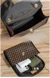 Detail of coffee geometric pattern crossbody bag interior showing spacious storage capacity