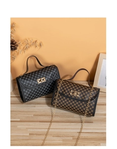 Detail of classic diamond quilted chain bags with vintage pattern and turn-lock closure