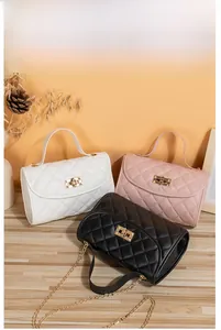 Quilted flap bags in ivory, pink, and black with gold turn-locks and chain straps