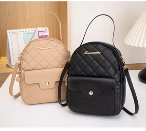 Quilted mini backpacks in black and beige with metallic buckles in a cozy indoor setting