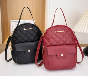 Close-up of quilted PU leather mini backpacks in black and burgundy with gold hardware