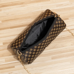 Brown monogram cylinder crossbody bag with golden clover pattern and chain strap