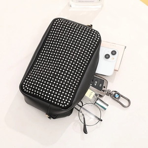 Black studded crossbody bag with silver rhinestones showing spacious interior capacity