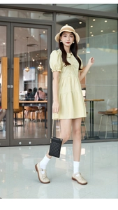 Mini yellow crossbody phone bag with quilted embroidery and metal chain strap details