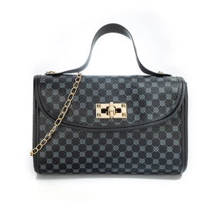 Quilted crossbody bag with grey flower pattern and gold chain strap on white background