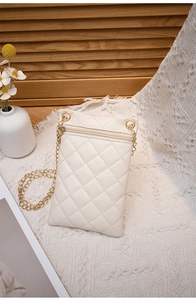 Detail of cream quilted phone bag featuring gold chain strap and zipper pocket