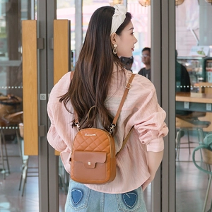 Women's brown mini quilted backpack with gold hardware and stylish adjustable straps