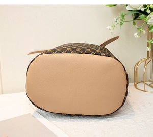 Détail de la base du sac seau vintage avec motif floral rétro et coutures en cuir brun