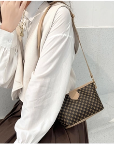 Detail view of vintage geometric print shoulder bag worn with casual beige outfit