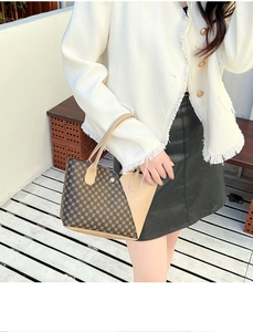 Dettaglio borsa a secchiello con motivi geometrici retrò e cuciture in pelle alla moda